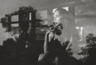 A thoughtful woman looking out a window, reflecting on her relationships.