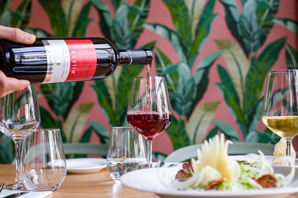 wine bottle beside wine glass on table