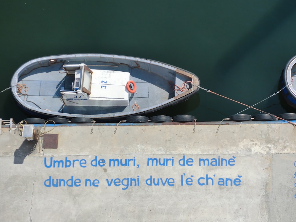 white and blue boat on water