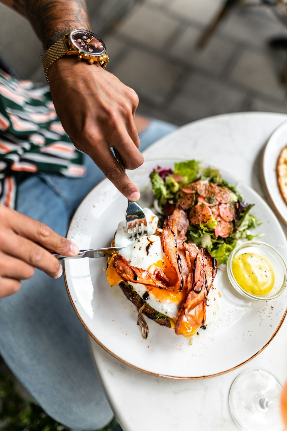 person holding stainless steel fork and knife