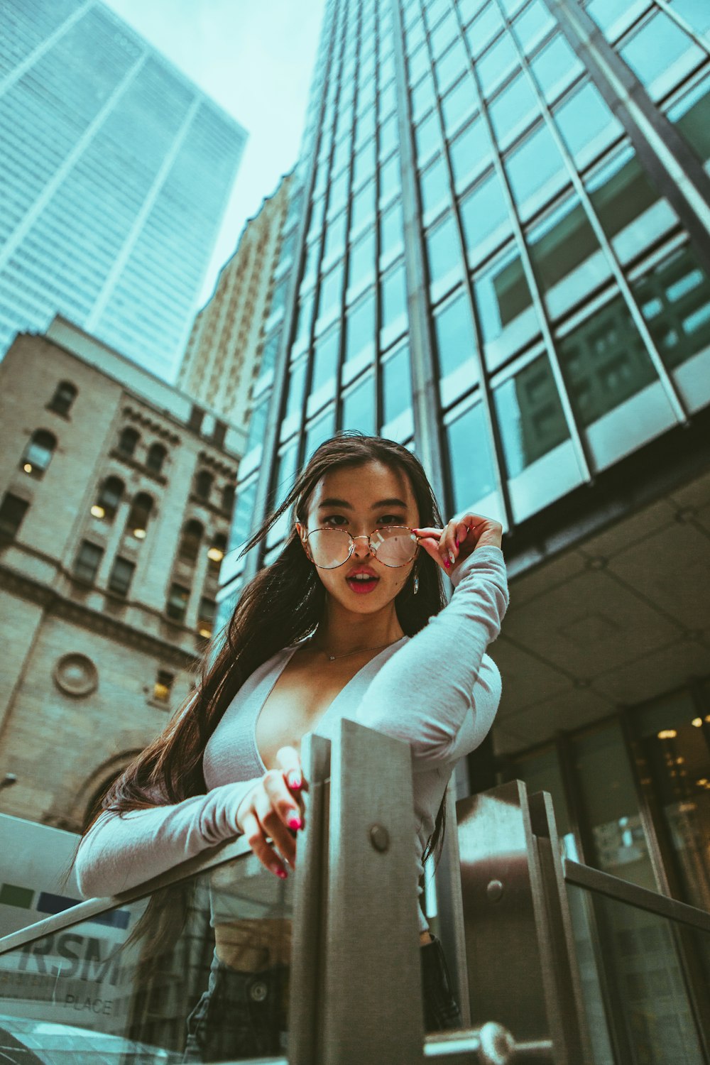 woman in gray long sleeve shirt holding smartphone