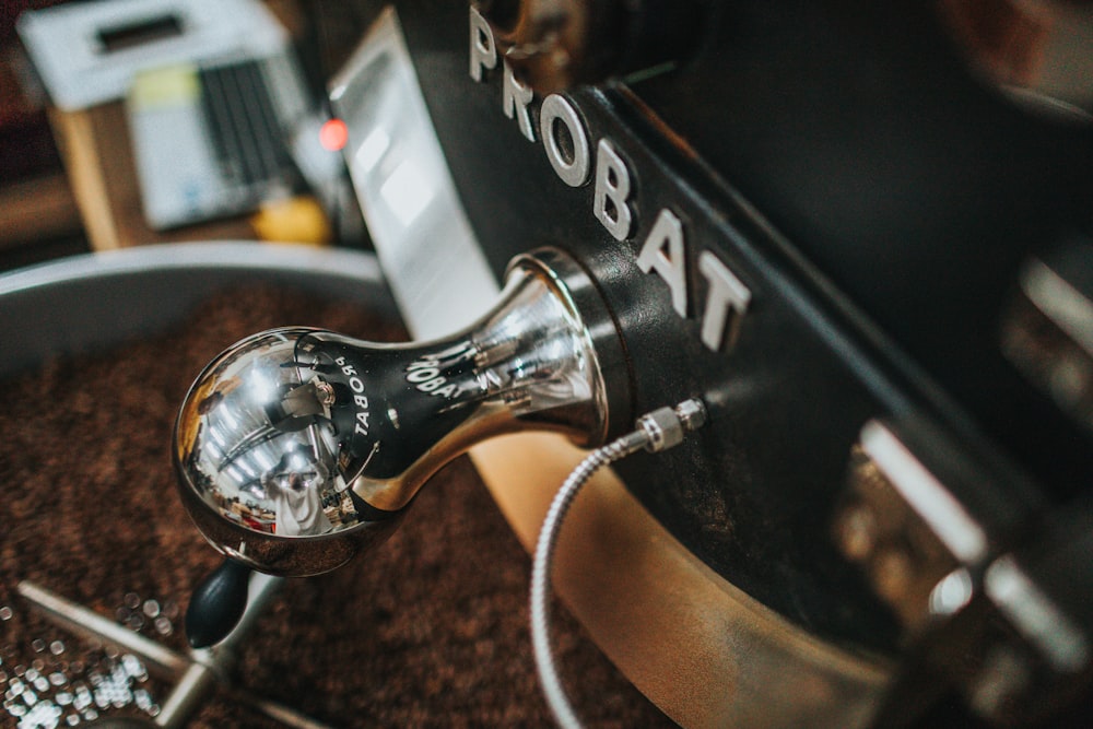 a coffee grinder with a cup of coffee on top of it