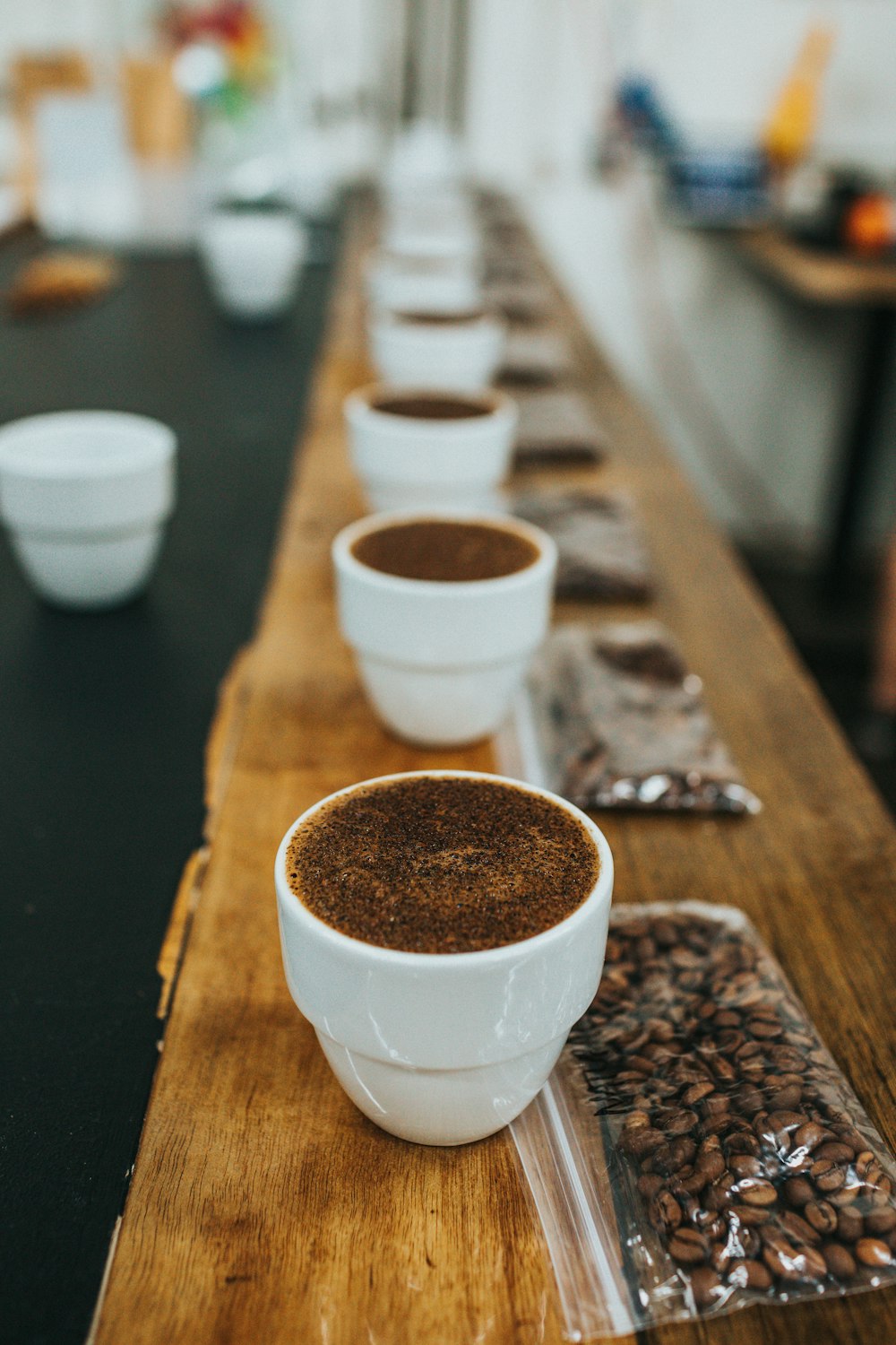 white ceramic cups on brown wooden table