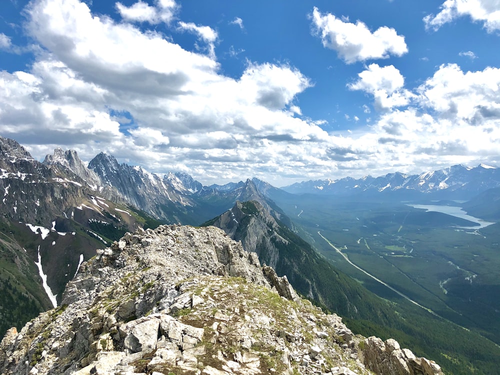 green and gray mountains under blue sky and white clouds during daytime