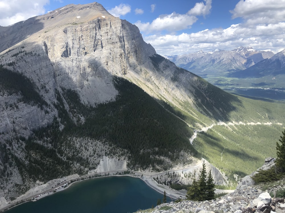 green lake near mountain under blue sky during daytime