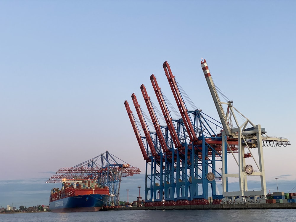 blue and red cargo ship on sea during daytime