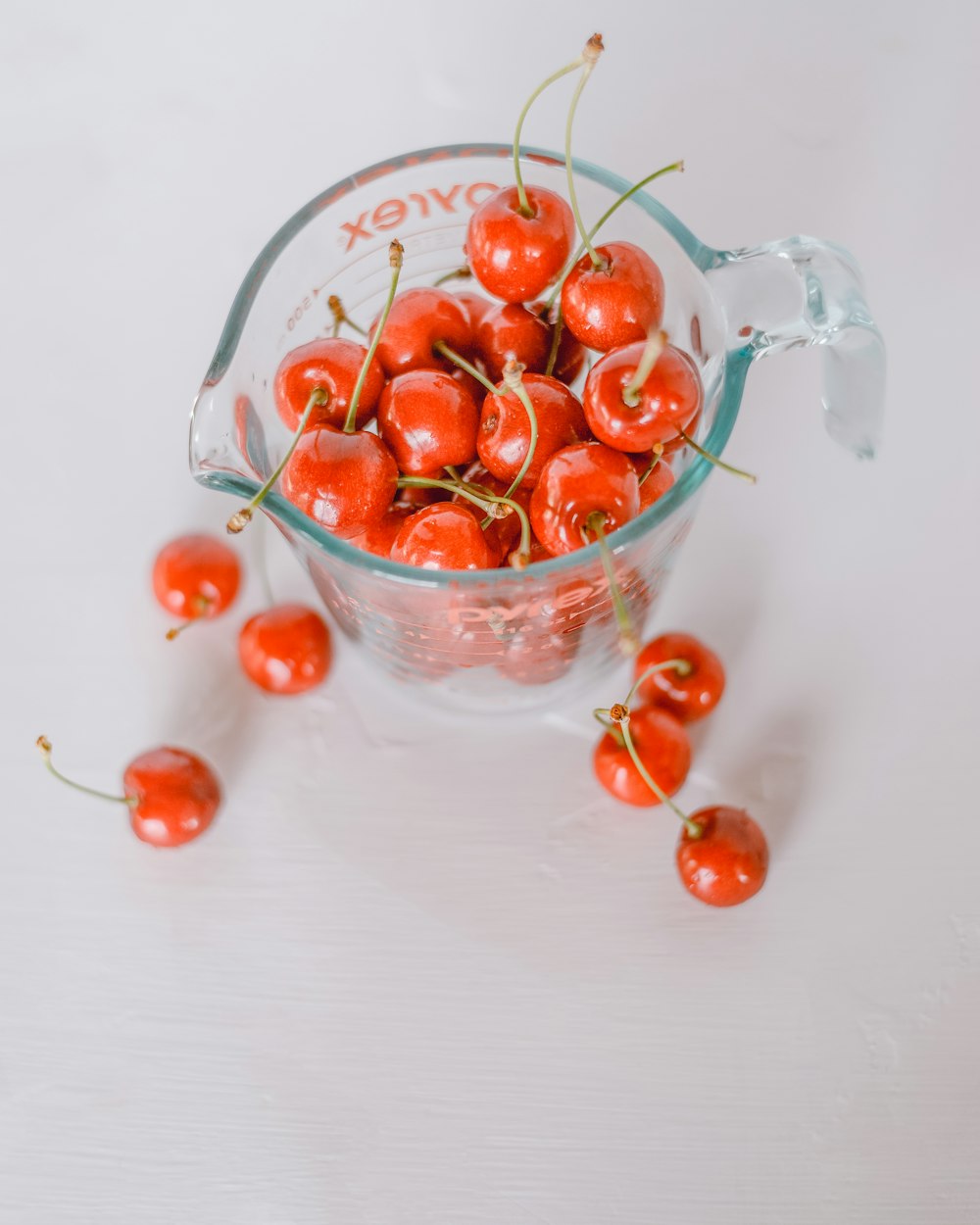 red cherries in clear glass bowl