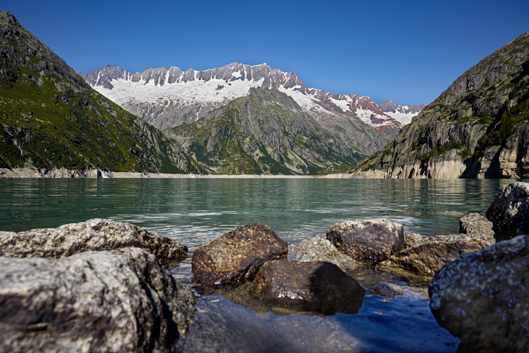 rocky shore with mountain in distance