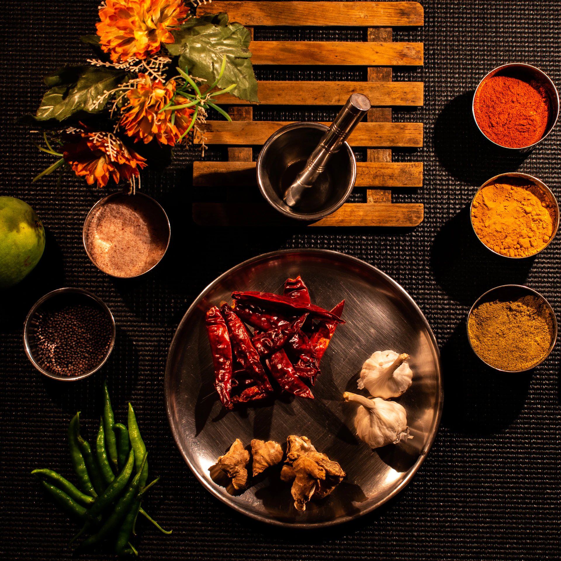sliced lemon on stainless steel bowl beside sliced lemon on black wooden table