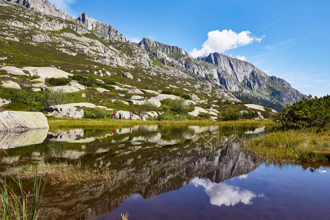 green and white mountains near body of water during daytime