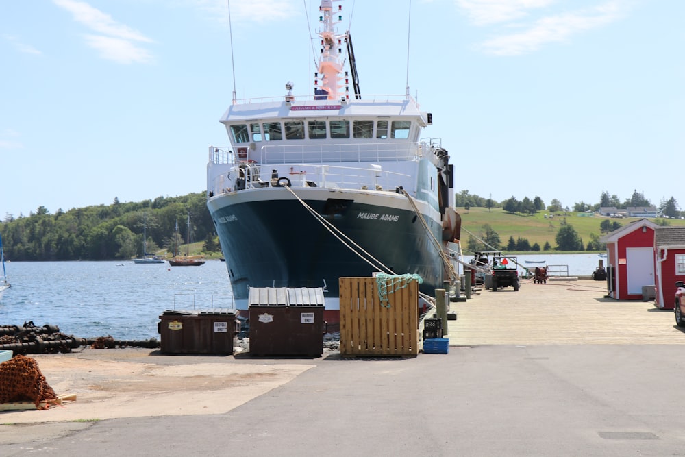 blue and white ship on dock during daytime