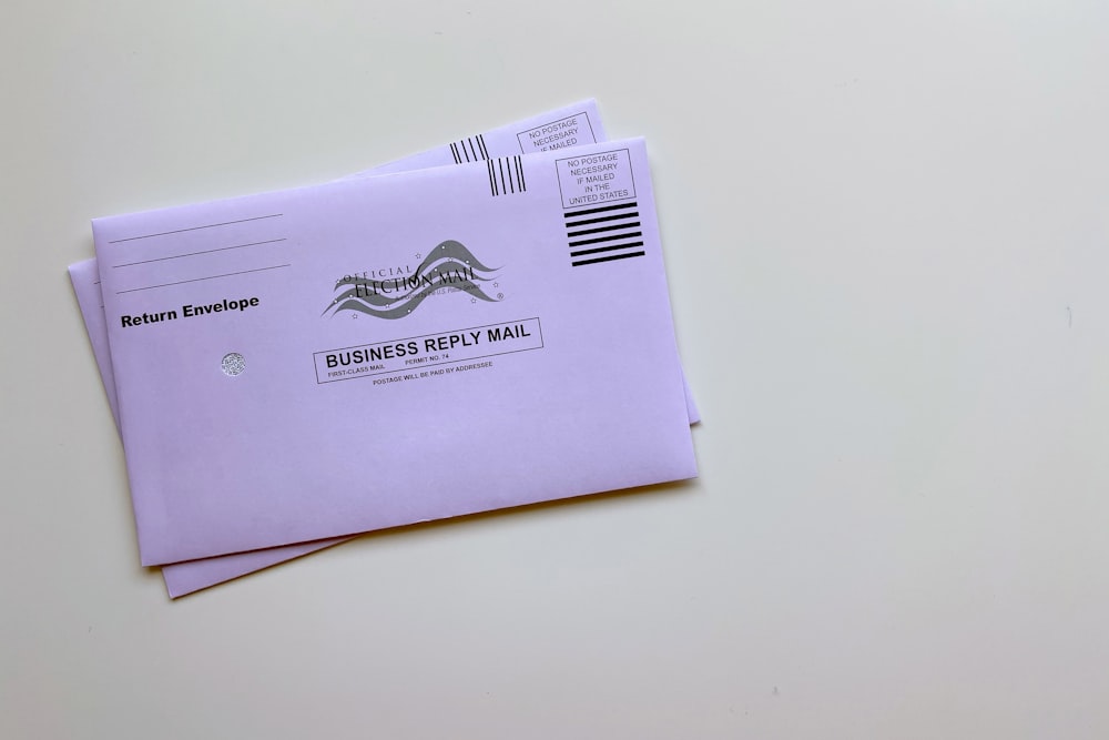 purple envelope on white table