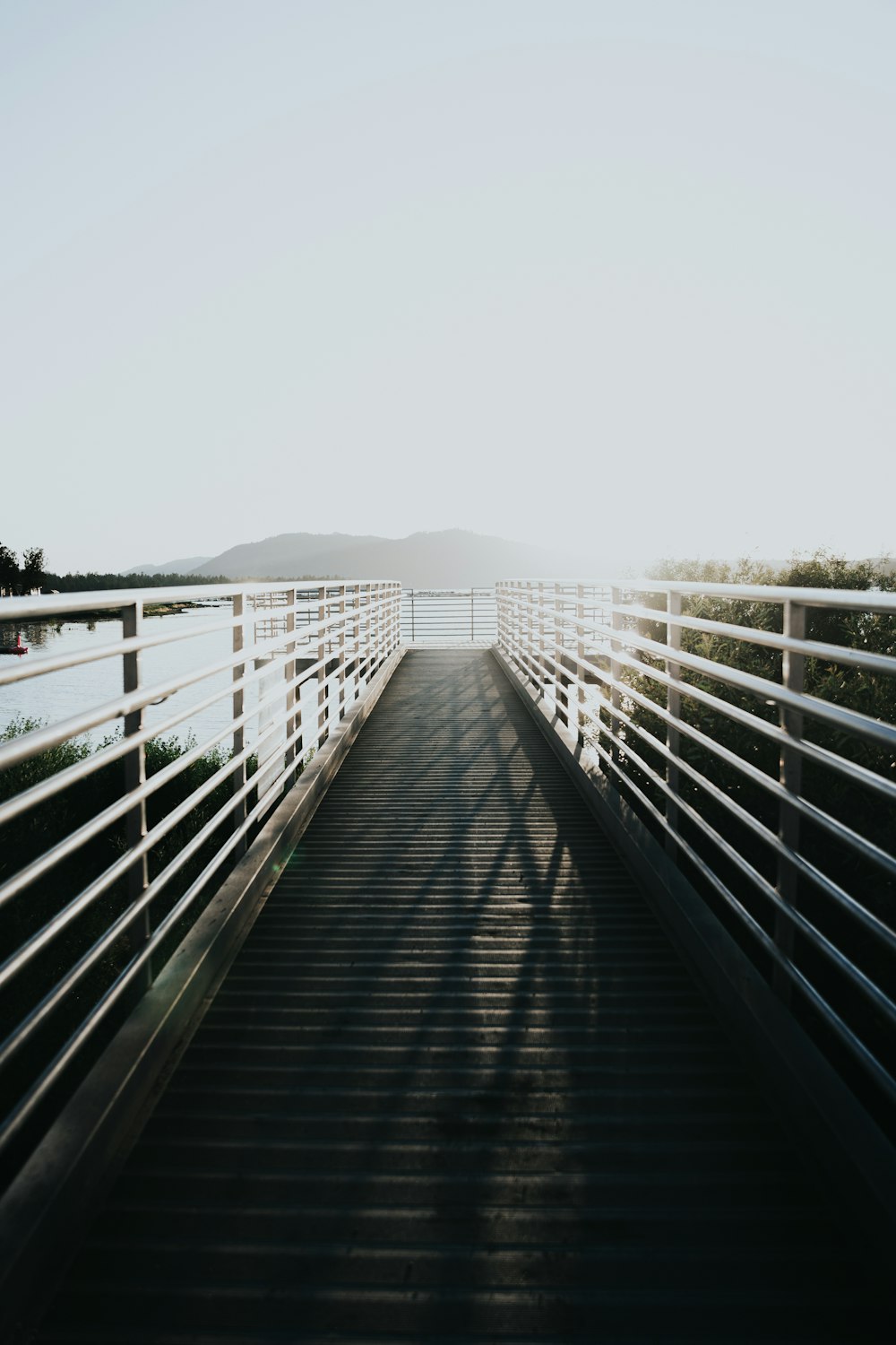 white wooden bridge over river during daytime