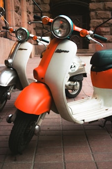 orange and white motor scooter