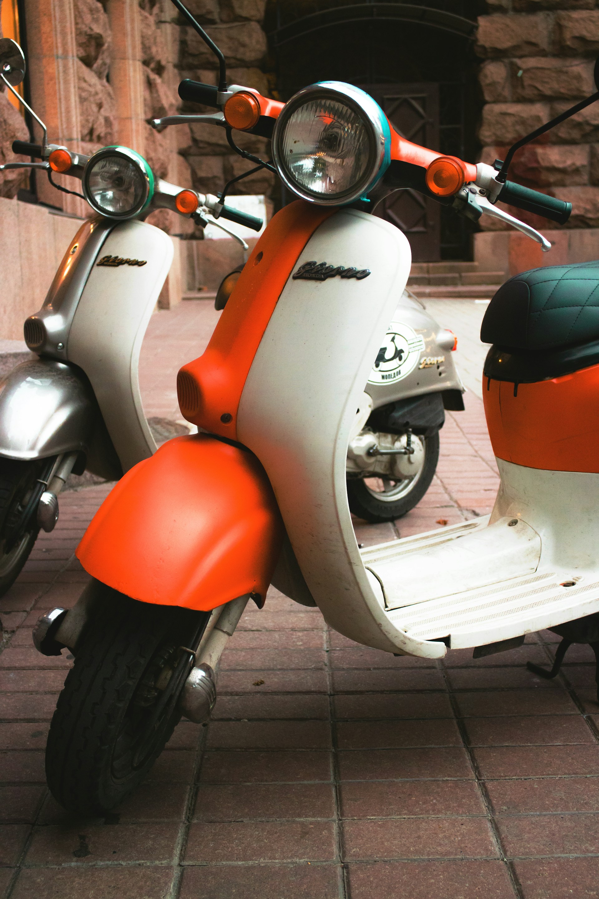 orange and white motor scooter