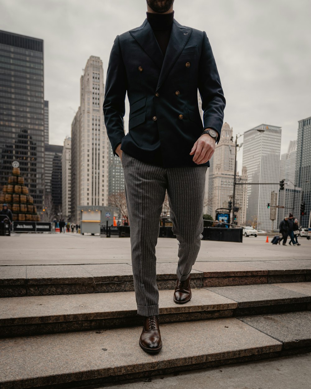 man in black coat standing on sidewalk during daytime