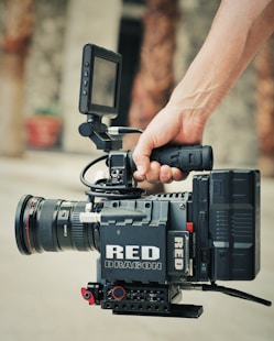 black video camera on persons hand