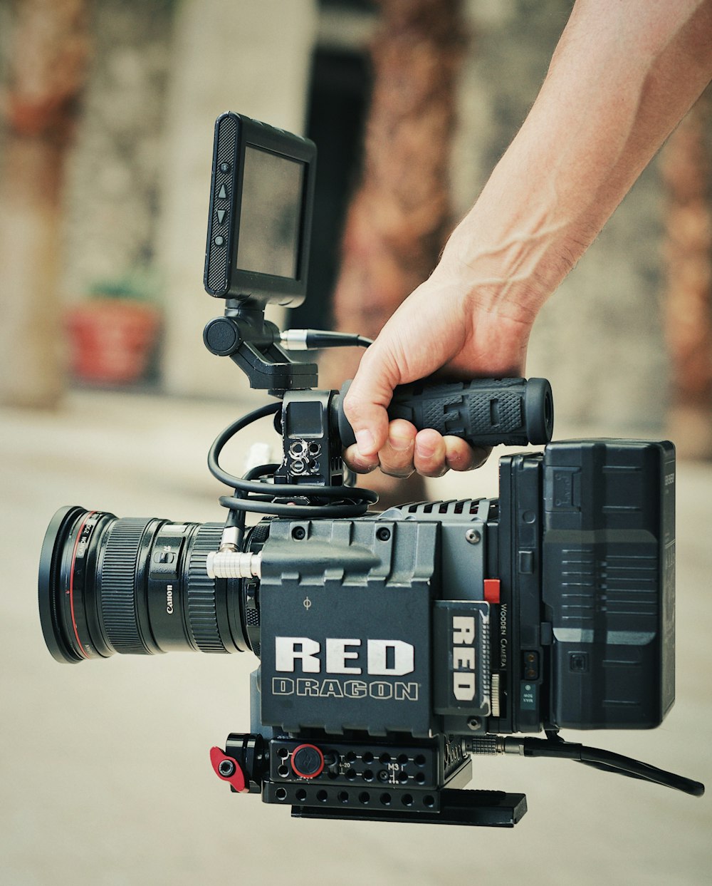 black video camera on persons hand