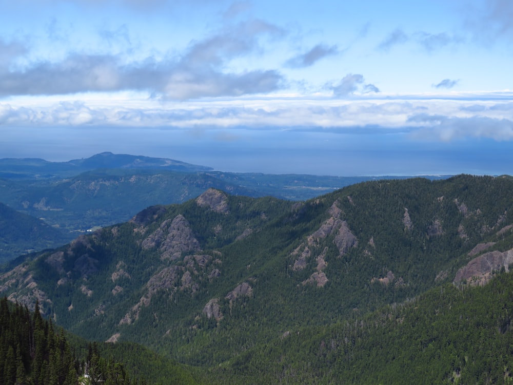 green mountains under white clouds during daytime