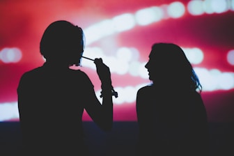 silhouette of woman holding microphone