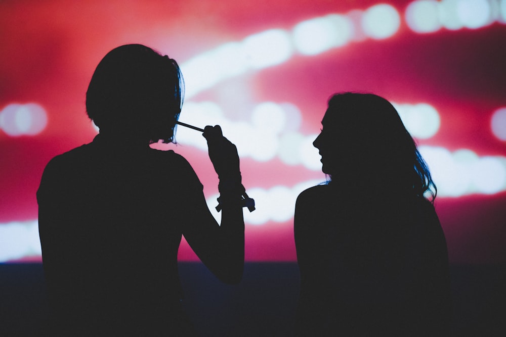 silhouette of woman holding microphone