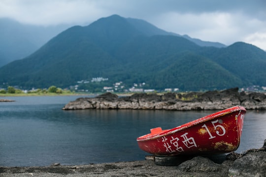 red kayak on gray sand near body of water during daytime in Mount Fuji Japan