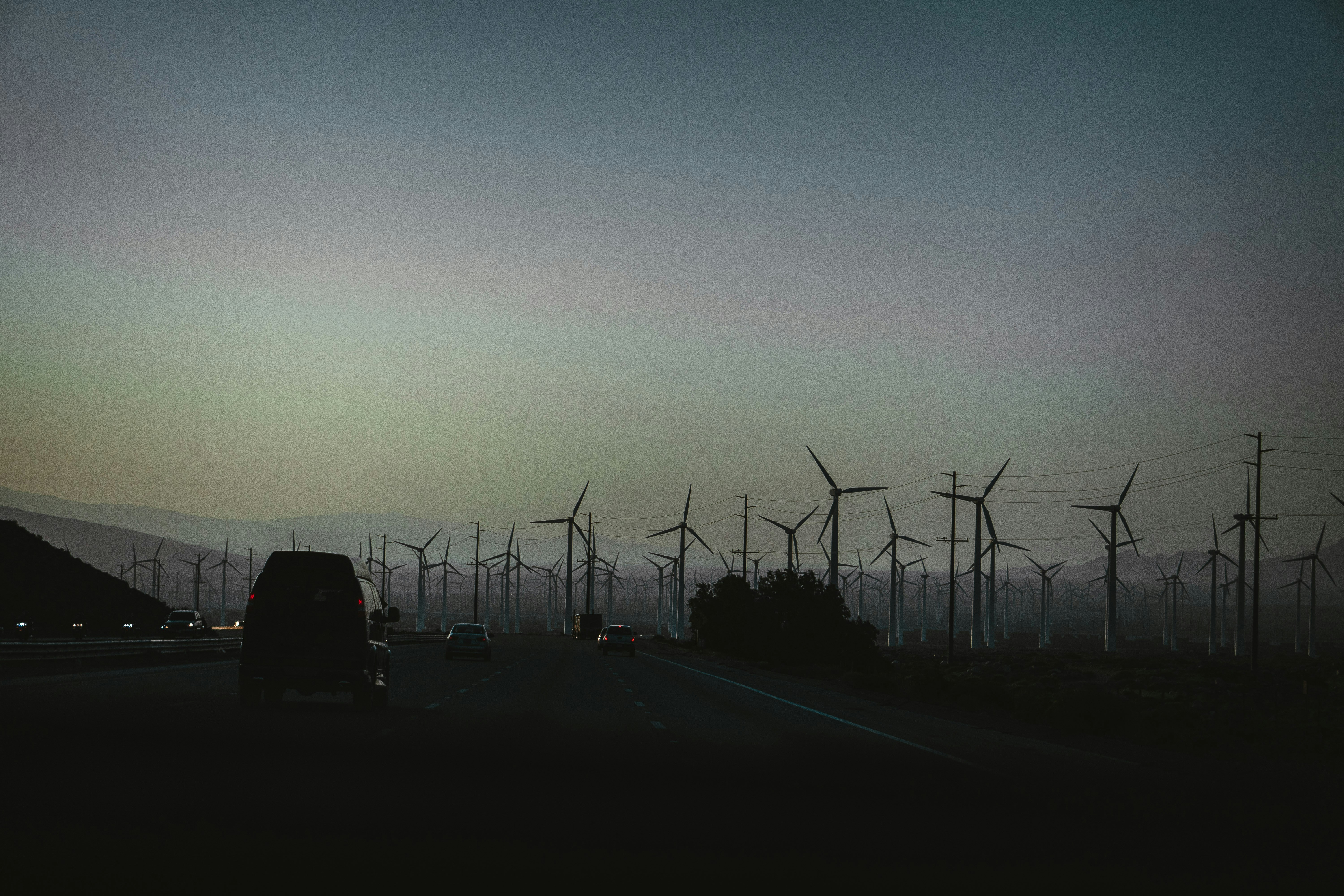 silhouette of electric post during sunset