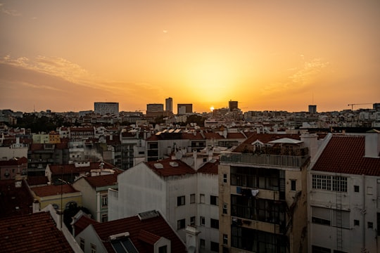 white and brown concrete buildings during sunset in Lisbon Portugal