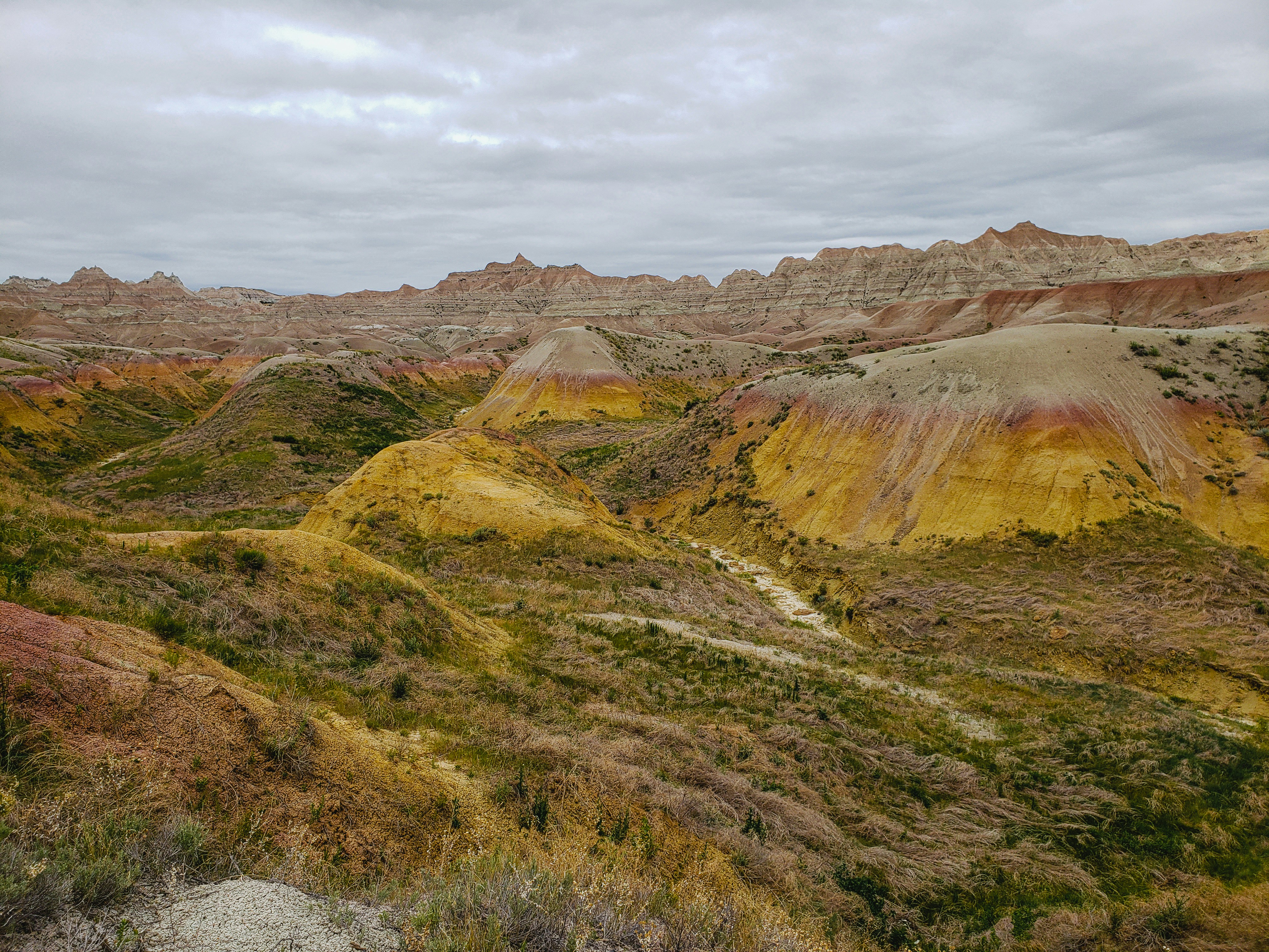 brown and green mountain under white clouds during daytime