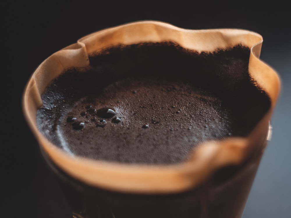 black liquid in brown ceramic mug