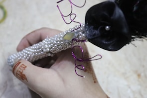 A preserved Indian varmala encased in glossy epoxy resin with delicate gold accents.