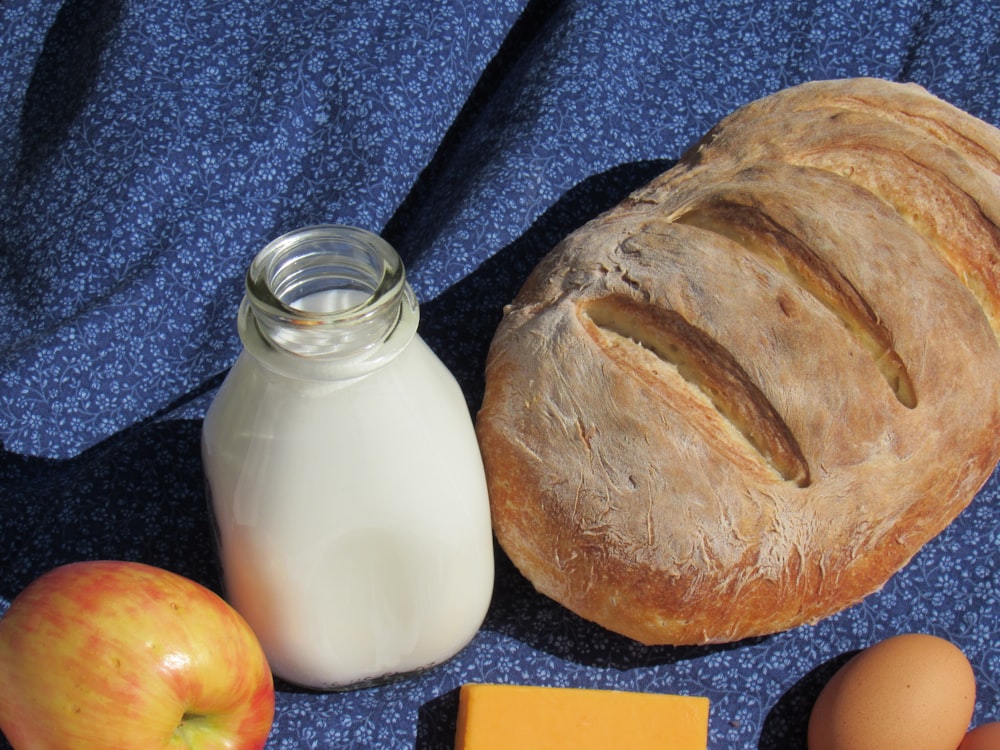 bread beside glass jar with milk