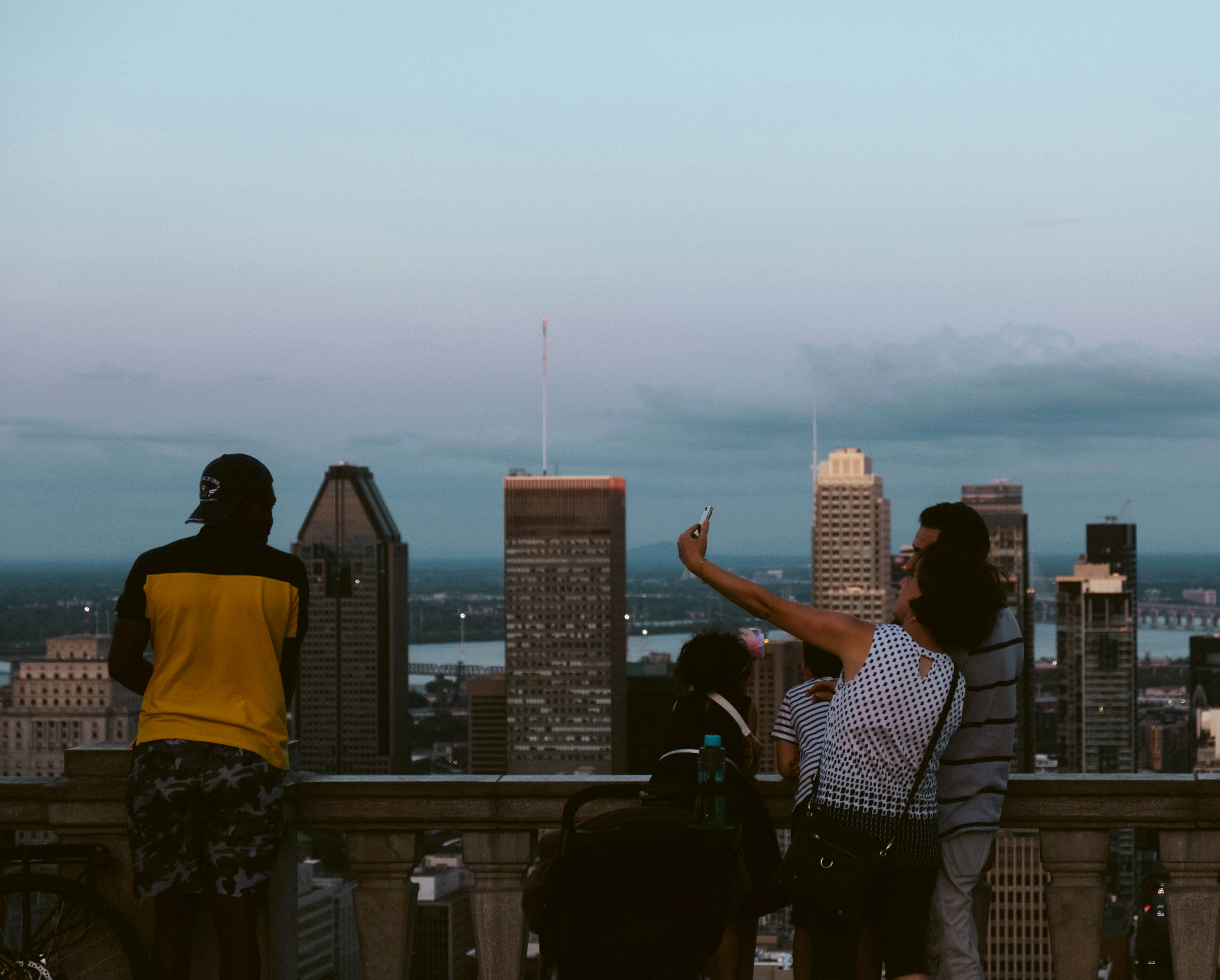 man in yellow t-shirt standing on building during daytime