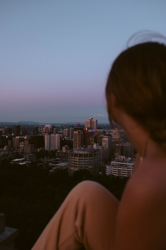 woman looking at the city during daytime in Mont Royal Canada