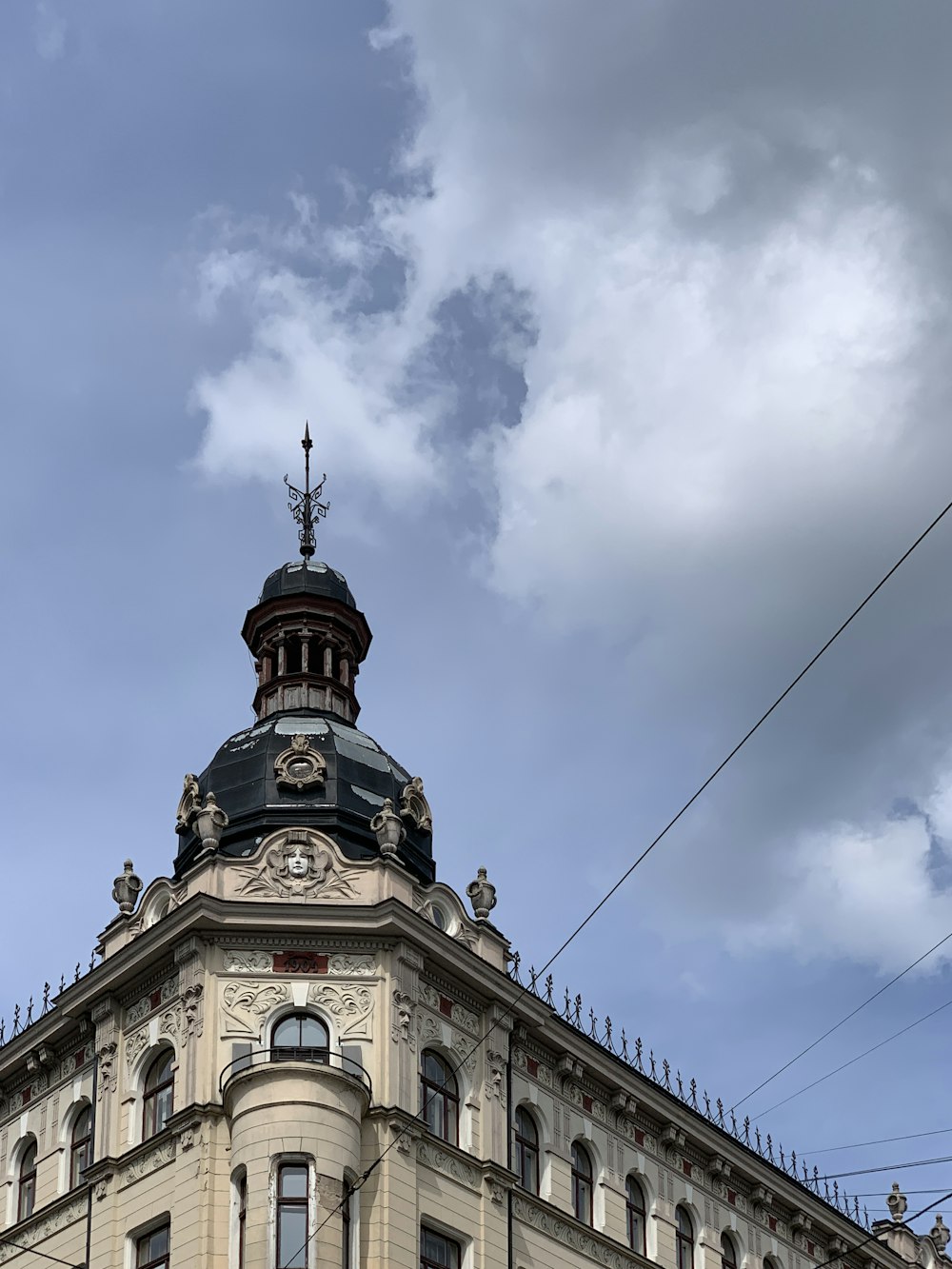 brown and black concrete building under blue sky