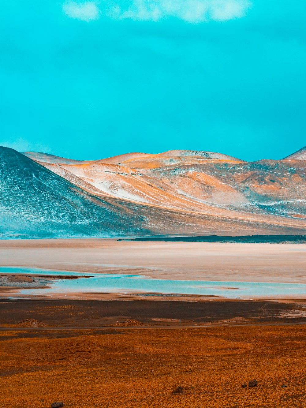 brown and gray mountains near body of water during daytime