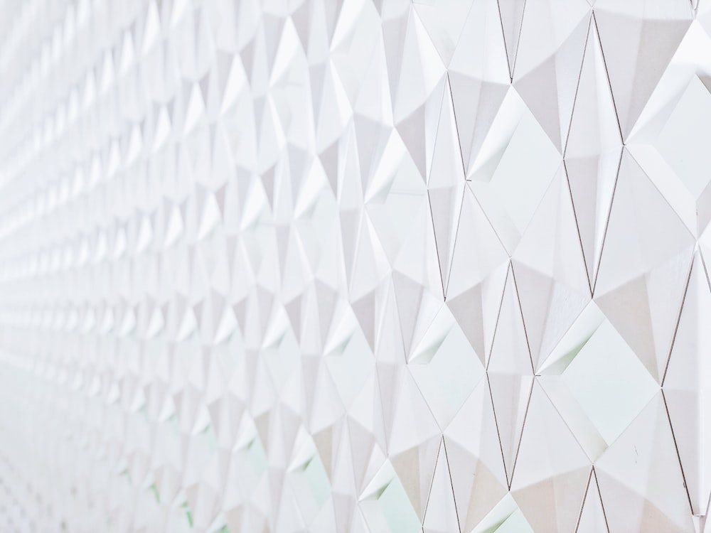 a close up of a white wall with a pattern on it