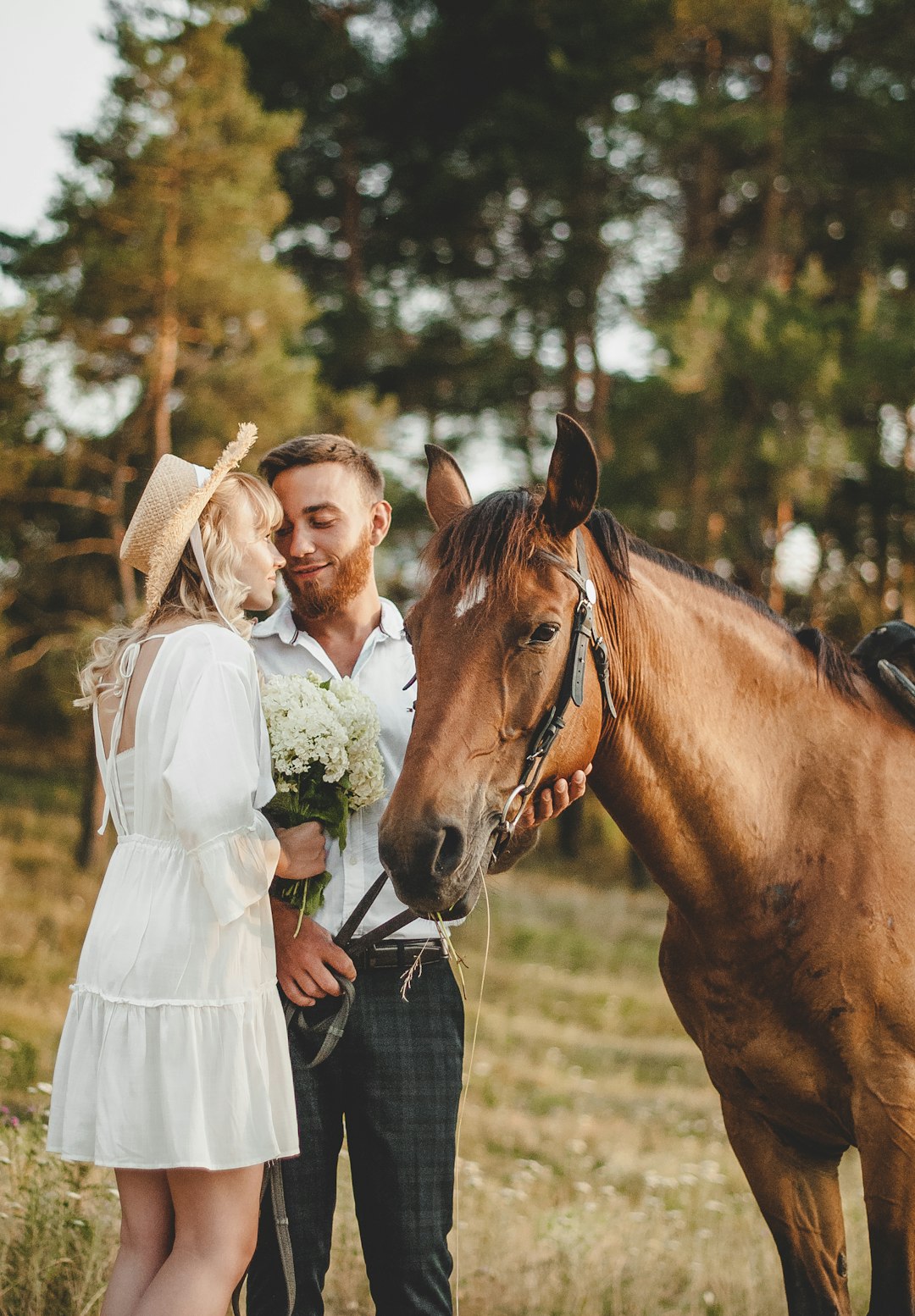 woman in white dress standing beside brown horse during daytime