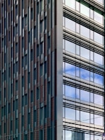Modern downtown Houston commercial building with glass windows reflecting the city skyline.