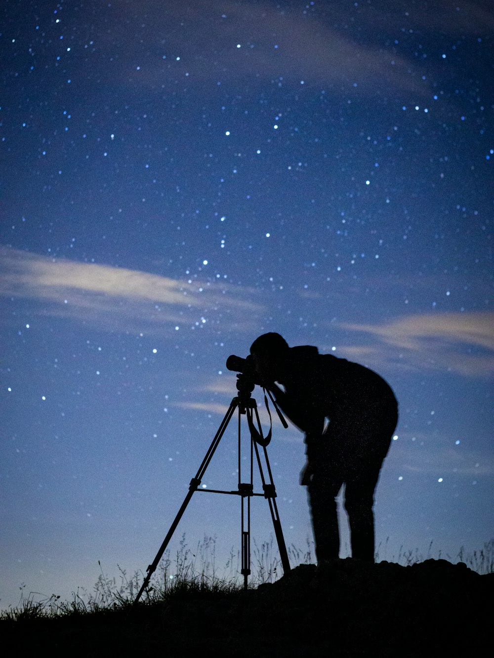 Silhouette eines Mannes, der unter der Sternennacht steht