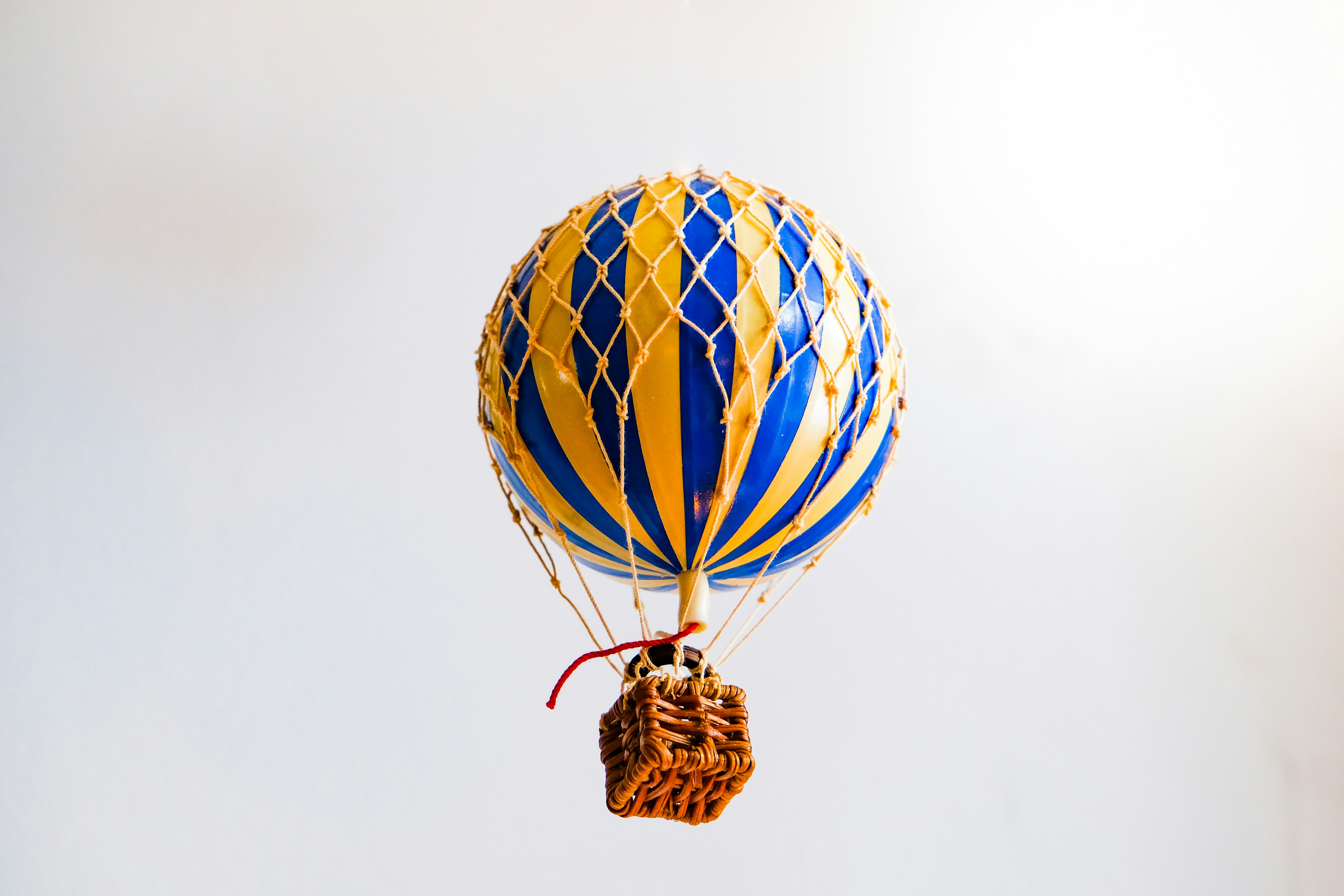 a blue and yellow hot air balloon flying in the sky