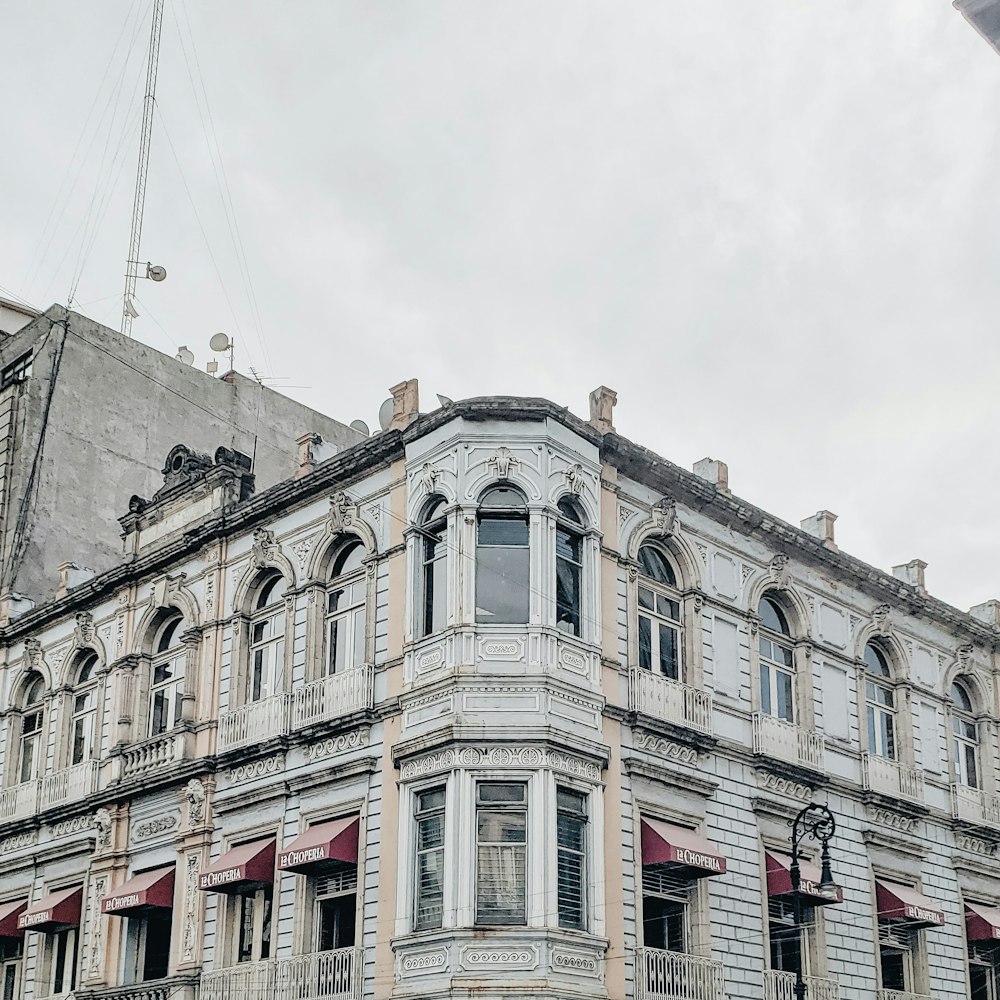 white and brown concrete building under white sky during daytime