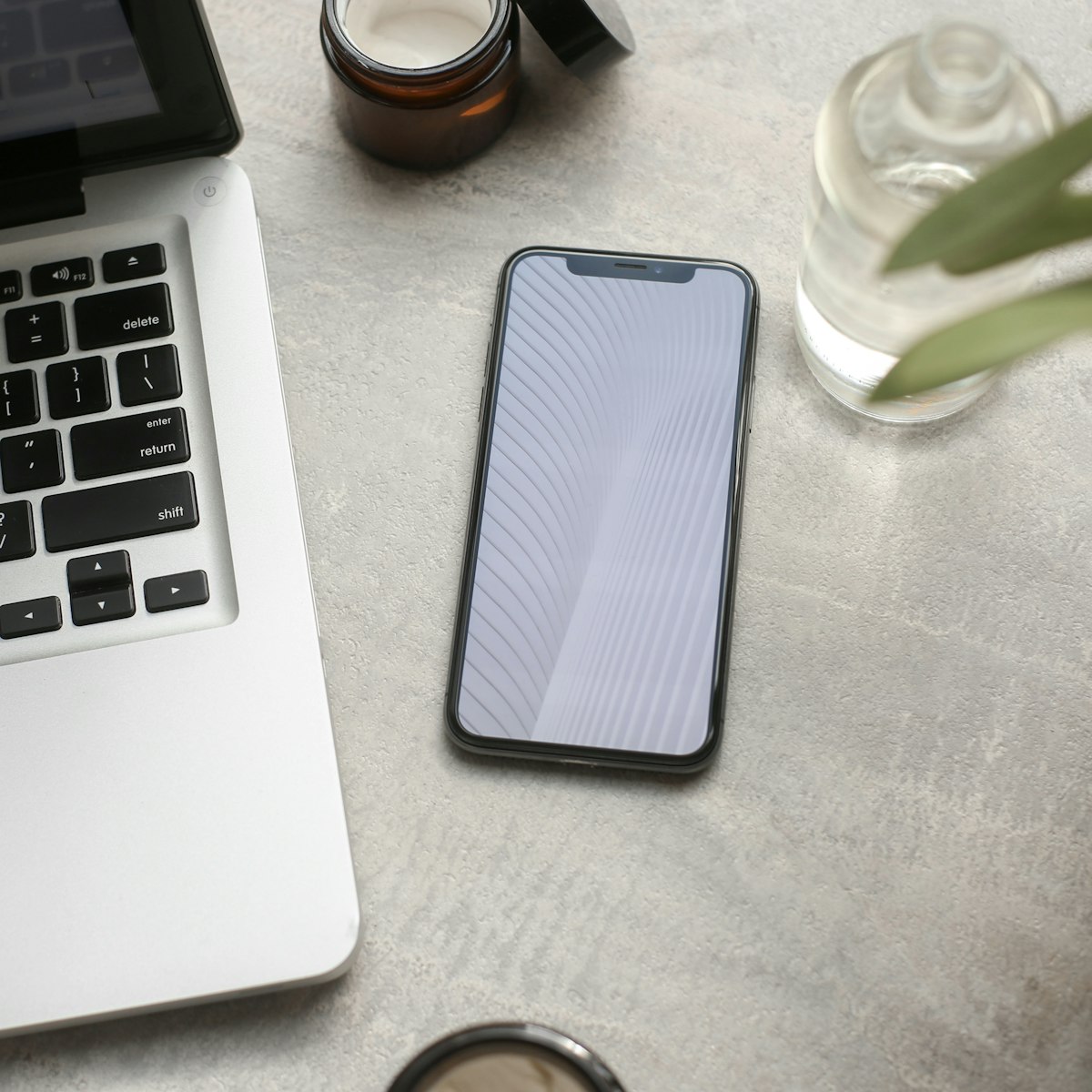 Phone lying next to a laptop, ready to pick up