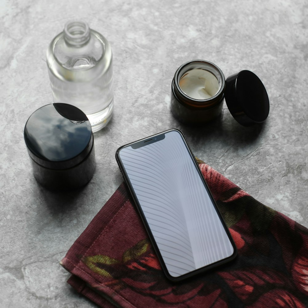 black round container beside clear glass jar