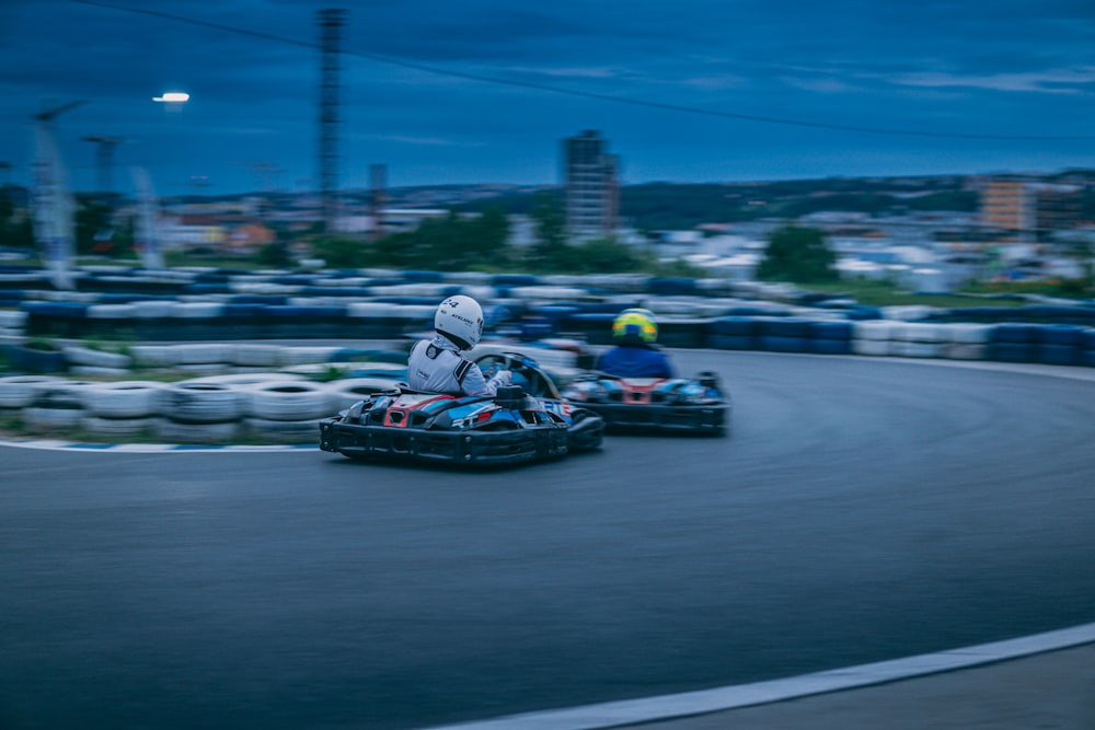 people riding go kart on road during nighttime