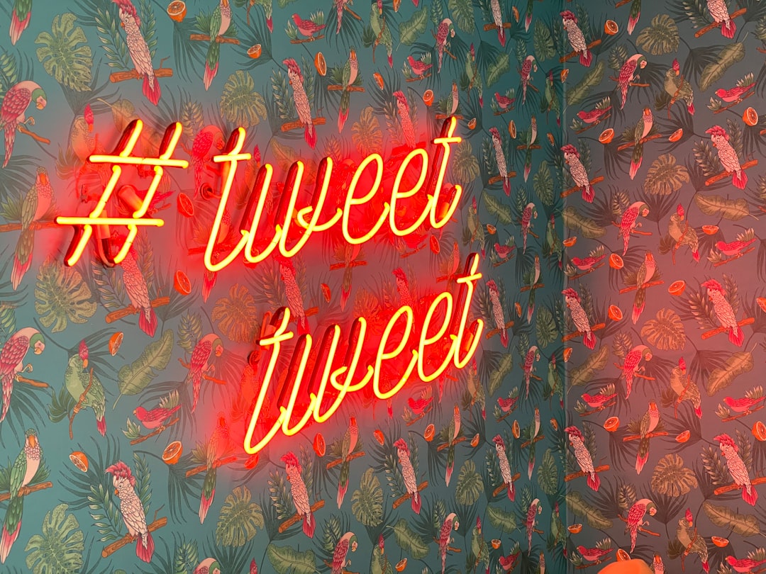 Hashtag symbol and Tweet, Tweet in orange neon