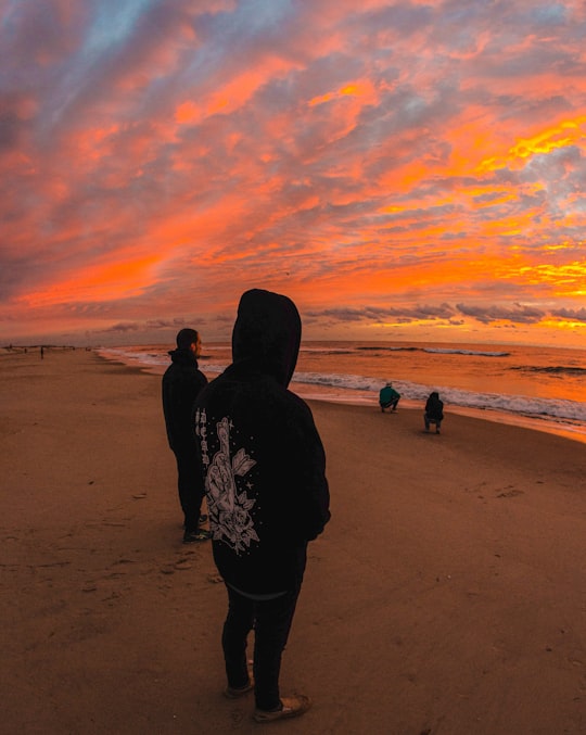 silhouette of person standing on beach during sunset in Assateague Island United States