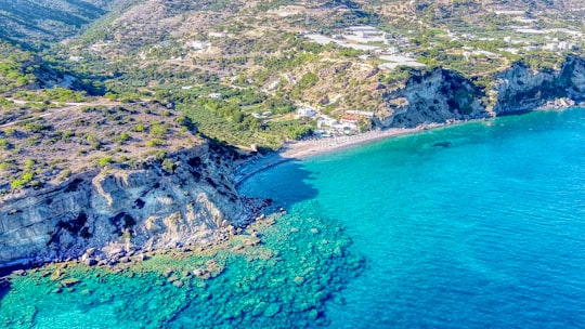 aerial view of green and gray mountain beside blue sea during daytime in Aghia Fotia Beach Greece
