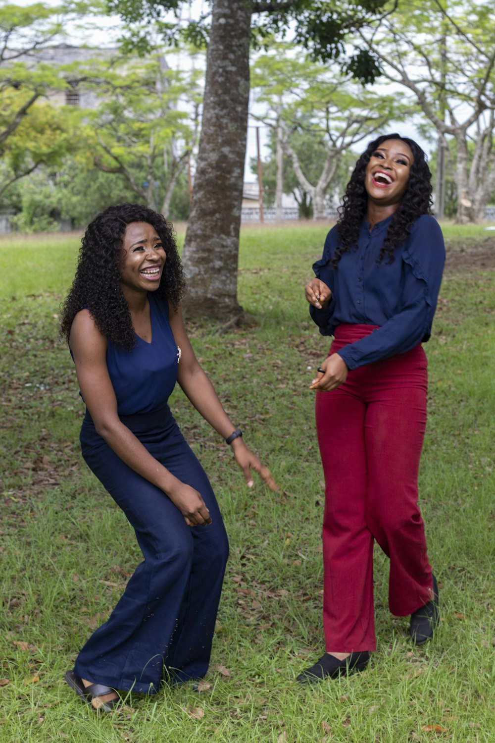 Woman in blue shirt and red pants standing beside woman in blue shirt photo  – Free Person Image on Unsplash