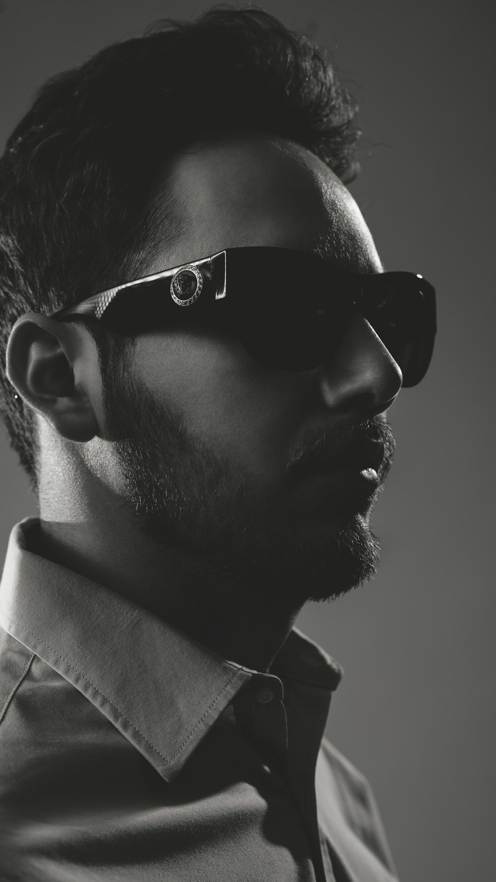 man in black sunglasses and white collared shirt